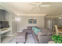 Bright living room featuring a sectional sofa and access to dining area at 3016 Bonfire Beach Dr # 104, Kissimmee, FL 34746