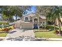 Beautiful two-story home showcasing lush landscaping, a spacious three-car garage, and a welcoming entrance at 3138 Jamber Dr, Ocoee, FL 34761