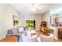 Light and bright living room with sliding glass doors leading to a patio, neutral decor, and hardwood floors at 3632 Calabria Ave, Davenport, FL 33897