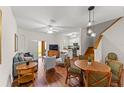 Open-concept living area with hardwood floors, cozy seating, and a modern kitchen in the background at 3632 Calabria Ave, Davenport, FL 33897