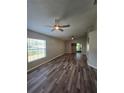Spacious living room featuring hardwood floors, ceiling fans, and natural light at 4002 August Ct, Casselberry, FL 32707