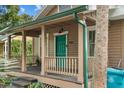 Inviting front porch with teal railing, and a wooden deck at 415 N Shine Ave, Orlando, FL 32803