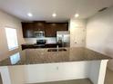 Modern kitchen with granite countertops and stainless steel appliances at 418 North Blvd East, Davenport, FL 33837