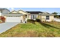 House exterior showcasing a single-story home with a garage and solar panels at 5504 Hamlin Close Rd, Davenport, FL 33896