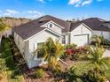 One story home with light green exterior, landscaping, and paver driveway at 636 Mosaic Blvd, Daytona Beach, FL 32124