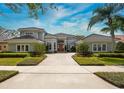 Elegant single-Gathering home with a tile roof, lush landscaping, and a brick driveway at 661 Cricklewood Ter, Lake Mary, FL 32746