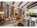 Spacious living room with custom built-ins, wooden beams, and plenty of comfortable seating at 661 Cricklewood Ter, Lake Mary, FL 32746