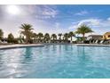 Relaxing community pool with lounge chairs and palm trees at 7387 Duxbury Ln, Winter Garden, FL 34787