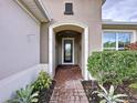 Brick walkway leading to a charming front door with a glass inset at 754 San Joaquin Rd, Kissimmee, FL 34759