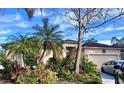 House with palm trees and well-maintained landscaping at 921 Rosinia Ct, Orlando, FL 32828