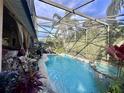 Screened-in pool and spa with tropical landscaping at 921 Rosinia Ct, Orlando, FL 32828