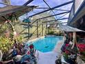 Relaxing screened-in pool area with lush landscaping at 921 Rosinia Ct, Orlando, FL 32828
