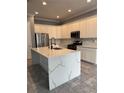 Modern kitchen featuring a large island and stainless steel appliances at 984 Maypole Dr, Apopka, FL 32703