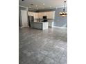 Open concept kitchen with an island and gray tile floors at 984 Maypole Dr, Apopka, FL 32703