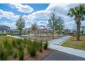 Community playground with climbing structures and swings, surrounded by lush landscaping and sidewalks at 9856 Sharpless Aly, Orlando, FL 32827