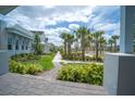 Street view with sidewalks, landscaping, palm trees, and playground in a residential community at 9856 Sharpless Aly, Orlando, FL 32827