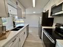 Updated kitchen with stainless steel appliances and white shaker cabinets at 1018 4Th St, Port Orange, FL 32129