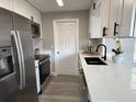 Modern kitchen featuring white cabinets, stainless steel appliances, and quartz countertops at 1018 4Th St, Port Orange, FL 32129