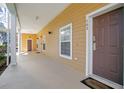 Exterior view of the building's facade with private entry and covered porch at 103 Rum Run # 103, Davenport, FL 33837