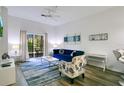 Bright living room with a stylish sofa, modern decor, and seamless flow to balcony at 103 Rum Run # 103, Davenport, FL 33837