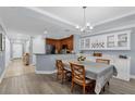 Dining room with wood floors and modern light fixture at 1358 Centre Court Ridge Dr # 202, Reunion, FL 34747
