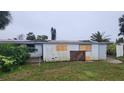 View of the back of the house needing repairs at 167 Benjamin Dr, Ormond Beach, FL 32176