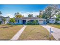 Ranch style home with a light blue exterior and landscaped yard at 1930 Albert Lee Pkwy, Winter Park, FL 32789