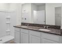 Double vanity bathroom with granite countertop at 2623 Sage Valley Way, Winter Haven, FL 33884