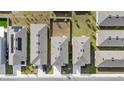 An overhead view of houses with gray roofs and green lawns at 2630 Angel Falls Dr, Davenport, FL 33837