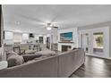 Spacious living room with fireplace, hardwood floors, and large windows at 3010 Bay Tree Dr, Orlando, FL 32806