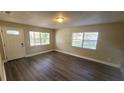 Bright and spacious living area with laminate flooring and large windows at 305 S Candler Ave, Orlando, FL 32835