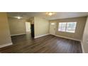 Open living area with laminate flooring, leading to the kitchen at 305 S Candler Ave, Orlando, FL 32835