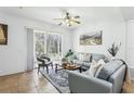 Spacious living room with light grey couches and access to a patio at 346 Monroe Cir, Davenport, FL 33896