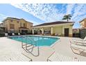Community pool with lounge chairs and covered seating area at 346 Monroe Cir, Davenport, FL 33896