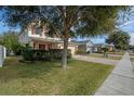 Two-story house on a tree-lined street with a brick driveway at 3720 Ryegrass St, Clermont, FL 34714