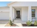 Inviting front porch with dark door and welcoming decor at 39641 Royal Trails Rd, Eustis, FL 32736