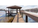 Wooden dock with covered seating area overlooking lake at 4135 Chuluota Rd, Orlando, FL 32820
