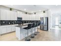 Modern kitchen with white cabinets, stainless steel appliances, and an island at 4152 Paragraph Dr, Kissimmee, FL 34746