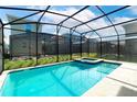 Inviting screened-in pool and jacuzzi in backyard at 4152 Paragraph Dr, Kissimmee, FL 34746