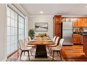 Elegant dining area with a modern table and hardwood floors at 4876 Conway Rd # 96, Orlando, FL 32812