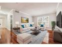 Bright living room with hardwood floors, comfy seating, and large window at 4876 Conway Rd # 96, Orlando, FL 32812