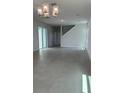 Open living room featuring tile flooring, modern lighting, and sliding glass doors at 520 Orient Ave, Debary, FL 32713