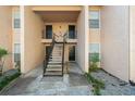 Condo building entrance with stairs and multiple unit doors at 670 Sandy Neck Ln # 103, Altamonte Springs, FL 32714