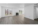 Bright living room with fireplace, wood-look floors and patio doors at 670 Sandy Neck Ln # 103, Altamonte Springs, FL 32714