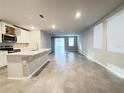 Open concept kitchen with island, stainless steel appliances, and tile flooring at 849 Rivers Crossing St, Clermont, FL 34714
