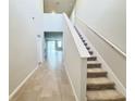 Bright entryway with tile flooring and carpeted staircase at 849 Rivers Crossing St, Clermont, FL 34714