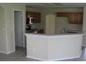 Well-lit kitchen featuring stainless steel appliances, wood cabinets, and breakfast bar at 11618 Grand Bay Blvd, Clermont, FL 34711