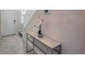 Bright entryway with tiled floor, glass-top console table, and staircase at 1016 Downswing Pl, Davenport, FL 33896