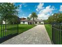 Charming home with an expansive green lawn, an elegant driveway, and secure fencing at 10416 Pocket Ln, Orlando, FL 32836