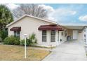 Welcoming single-story home featuring a covered carport and manicured landscaping at 1207 Palmetto Dr, Lady Lake, FL 32159
